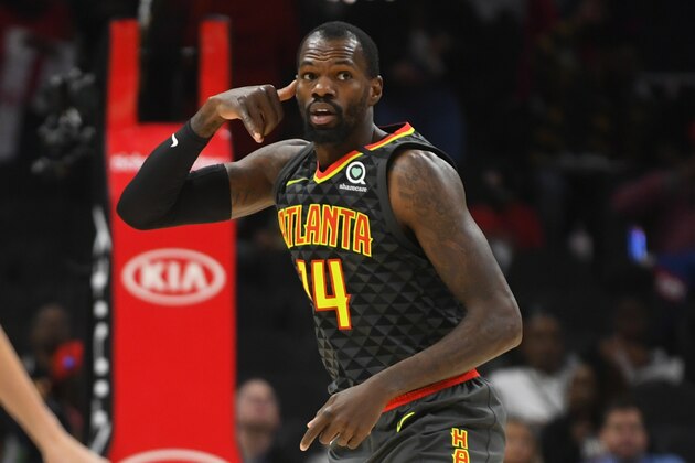 Atlanta Hawks center Dewayne Dedmon reacts aftrer scoring against the Charlotte Hornets during the first half of an NBA basketball game Monday, March 9, 2020, in Atlanta. (AP Photo/John Amis)
