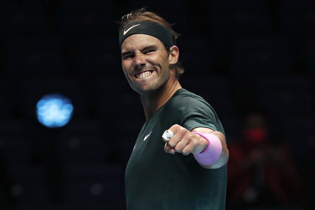 Rafael Nadal of Spain celebrates defeating Stefanos Tsitsipas of Greece during their tennis match at the ATP World Finals tennis tournament at the O2 arena in London, Thursday, Nov. 19, 2020. (AP Photo/Frank Augstein)