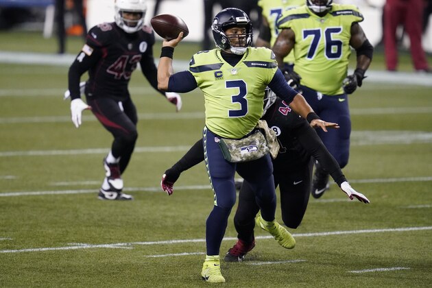 Seattle Seahawks quarterback Russell Wilson passes to DK Metcalf (not shown) for a touchdown during the first half of an NFL football game against the Arizona Cardinals, Thursday, Nov. 19, 2020, in Seattle. (AP Photo/Elaine Thompson)