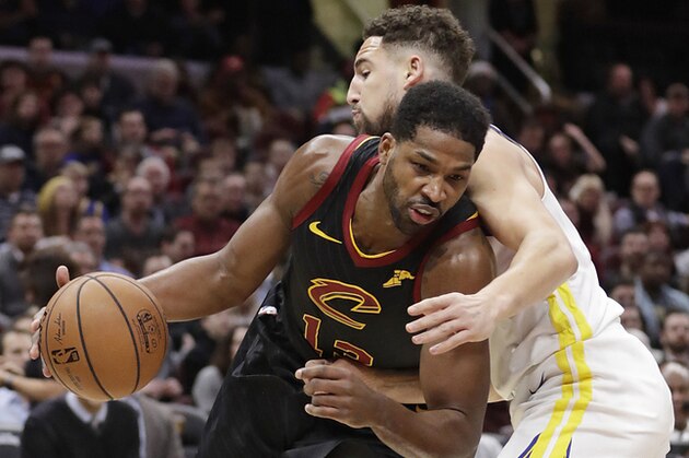 Cleveland Cavaliers' Tristan Thompson (13) drives past Golden State Warriors' Klay Thompson (11) in the first half of an NBA basketball game, Wednesday, Dec. 5, 2018, in Cleveland. (AP Photo/Tony Dejak)