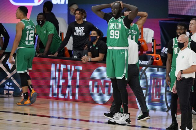 Boston Celtics' Tacko Fall (99) holds his hands on his head as the Celtics fall to the Toronto Raptors in the second half of an NBA conference semifinal playoff basketball game Thursday, Sept 3, 2020, in Lake Buena Vista Fla. (AP Photo/Mark J. Terrill)