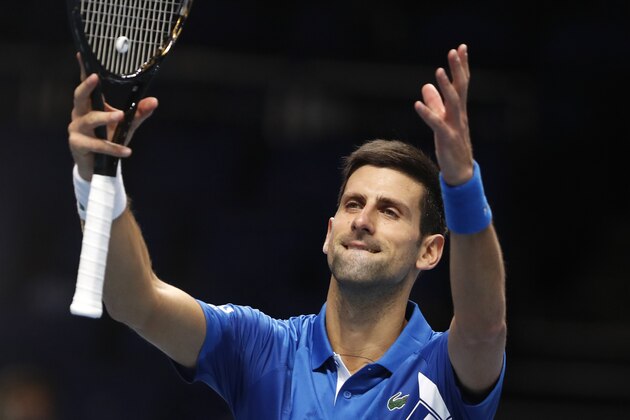 Novak Djokovic of Serbia celebrates winning match point against Alexander Zverev of Germany during their singles tennis match at the ATP World Finals tennis tournament at the O2 arena in London, Friday, Nov. 20, 2020. (AP Photo/Frank Augstein)