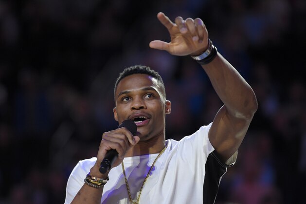 Former UCLA basketball player and current player for the Oklahoma Thunder Russell Westbrook speaks to the crowd after being honored with a basketball court named after him following the first half of an NCAA college basketball game between UCLA and Arizona, Thursday, Jan. 7, 2016, in Los Angeles. (AP Photo/Mark J. Terrill)