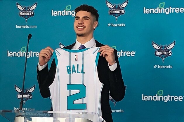 LaMelo Ball, selected by the Charlotte Hornets with the No. 3 overall pick in the NBA draft, holds up his jersey during an introductory news conference on Friday, Nov. 20, 2020, in Charlotte, N.C. (AP Photo/Steve Reed)