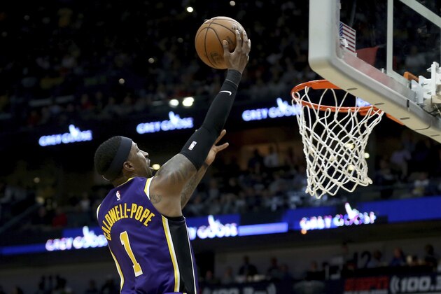 Los Angeles Lakers guard Kentavious Caldwell-Pope (1) goes for a layup in the first half of an NBA basketball game in New Orleans, Sunday, March 1, 2020. (AP Photo/Rusty Costanza)