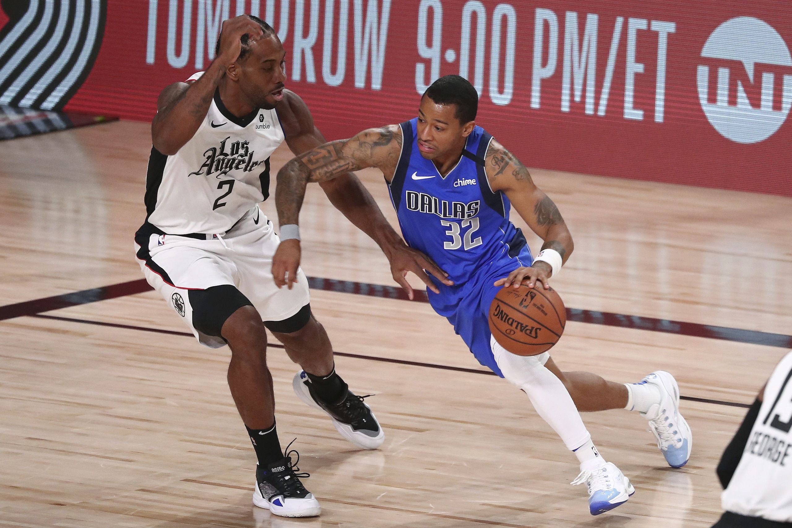 Dallas Mavericks guard Trey Burke (32) drives against Los Angeles Clippers forward Kawhi Leonard (2) during the first half of Game 5 of an NBA basketball first-round playoff series, Tuesday, Aug. 25, 2020, in Lake Buena Vista, Fla. (Kim Klement/Pool Photo via AP)