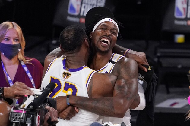 Los Angeles Lakers' LeBron James (23) and Los Angeles Lakers' Dwight Howard (39) celebrate after the Lakers defeated the Miami Heat 106-93 in Game 6 of basketball's NBA Finals Sunday, Oct. 11, 2020, in Lake Buena Vista, Fla. (AP Photo/Mark J. Terrill)
