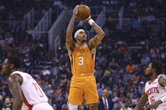 Phoenix Suns forward Kelly Oubre Jr. (3) shoots a three-point basket between Houston Rockets guards Ben McLemore (16) and Michael Frazier (21) during the second half of an NBA basketball game Friday, Feb. 7, 2020, in Phoenix. (AP Photo/Ross D. Franklin)