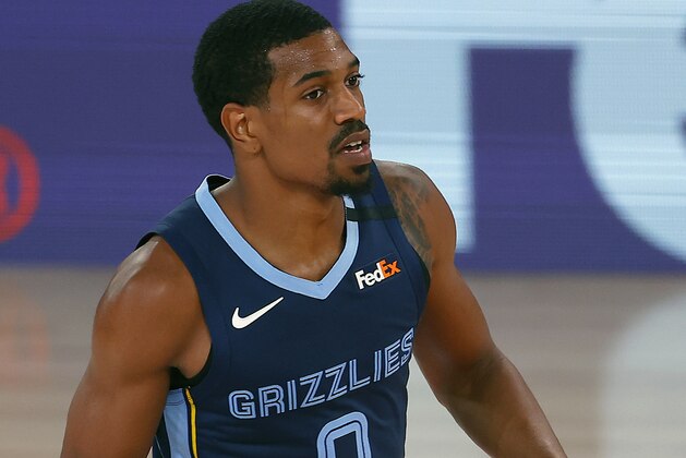 Memphis Grizzlies' De'Anthony Melton dribbles the ball down court during the first half of an NBA basketball game against the Boston Celtics Tuesday, Aug. 11, 2020, in Lake Buena Vista, Fla. (AP Photo/Mike Ehrmann, Pool)