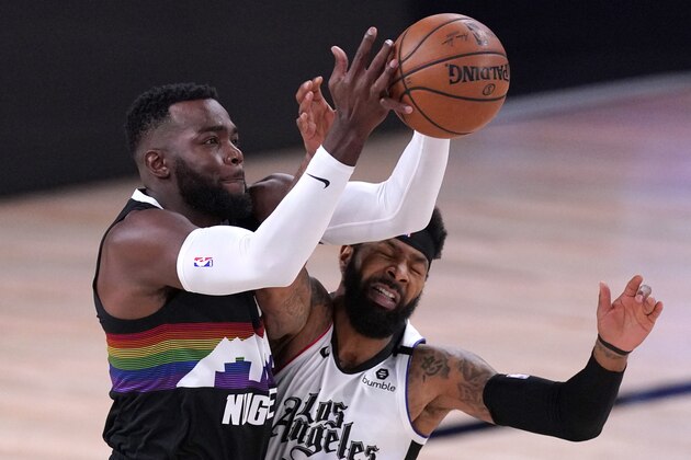 Los Angeles Clippers' Marcus Morris Sr., right, and Denver Nuggets' Paul Millsap reach for ball during the first half of an NBA conference semifinal playoff basketball game Sunday, Sept. 13, 2020, in Lake Buena Vista, Fla. (AP Photo/Mark J. Terrill)