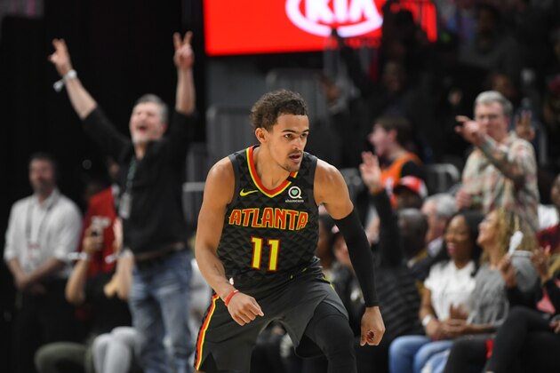 Fans cheer as Atlanta Hawks guard Trae Young turns upcourt afetr scoring against the Charlotte Hornets during an NBA basketball game Monday, March 9, 2020, in Atlanta. (AP Photo/John Amis)