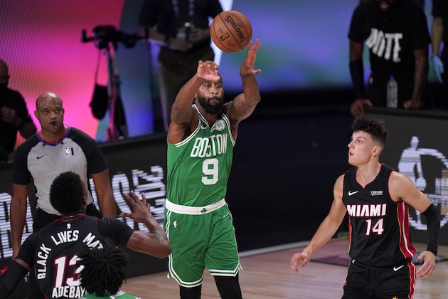 Miami Heat forward Bam Adebayo (13) and Tyler Herro (14) defend against a pass by Boston Celtics' Brad Wanamaker (9) during the first half of Game 4 of an NBA basketball Eastern Conference final, Wednesday, Sept. 23, 2020, in Lake Buena Vista, Fla. (AP Photo/Mark J. Terrill)