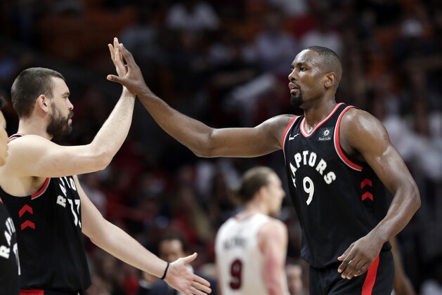 Toronto Raptors center Marc Gasol, left, high-fives center Serge Ibaka (9) during the second half of an NBA basketball game against the Miami Heat, Sunday, March 10, 2019, in Miami. The Raptors won 125-104. (AP Photo/Lynne Sladky)