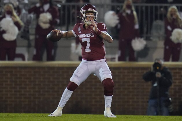 Oklahoma quarterback Spencer Rattler looks for a receiver during the first half of the team's NCAA college football game against Oklahoma State in Norman, Okla., Saturday, Nov. 21, 2020. (AP Photo/Sue Ogrocki)
