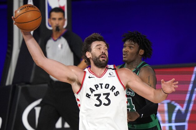 Toronto Raptors' Marc Gasol (33) grabs a pass as Boston Celtics' Robert Williams III (44) defends in the second half of an NBA conference semifinal playoff basketball game, Tuesday, Sept. 1, 2020, in Lake Buena Vista, Fla. (AP Photo/Mark J. Terrill)