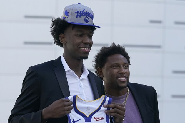 Golden State Warriors draft pick James Wiseman, left, poses next to agent Marcus Monk in San Francisco, Thursday, Nov. 19, 2020. (AP Photo/Jeff Chiu)