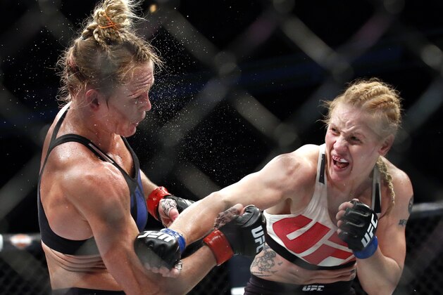 FILE - In this July 23, 2016, file photo, Valentina Shevchenko, right, of Kyrgyzstan, follows through on a punch to Holly Holm during a women's bantamweight mixed martial arts bout in Chicago. Shevchenko is a Soviet-born Peruvian from Kyrgyzstan who does her mixed martial arts training in Thailand and the U.S. This avid traveler, dance contest winner and recent restaurant shooting survivor also might be the UFC's new bantamweight champion after her rematch with Amanda Nunes on Saturday, July 8, 2017. (AP Photo/Nam Y. Huh, File)