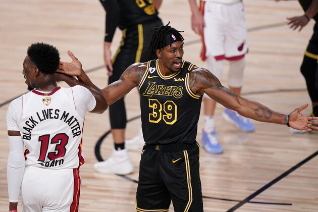 Los Angeles Lakers center Dwight Howard, right, reacts as Miami Heat forward Bam Adebayo looks way during the first half in Game 5 of basketball's NBA Finals Friday, Oct. 9, 2020, in Lake Buena Vista, Fla. (AP Photo/Mark J. Terrill)