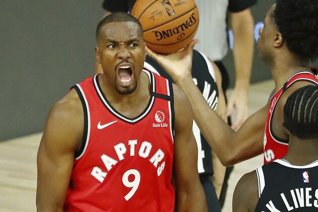 Toronto Raptors center Serge Ibaka (9) celebrates after making a basket against the Brooklyn Nets during the second half in Game 3 of an NBA basketball first-round playoff series, Friday, Aug. 21, 2020, in Lake Buena Vista, Fla. (Kim Klement/Pool Photo via AP)