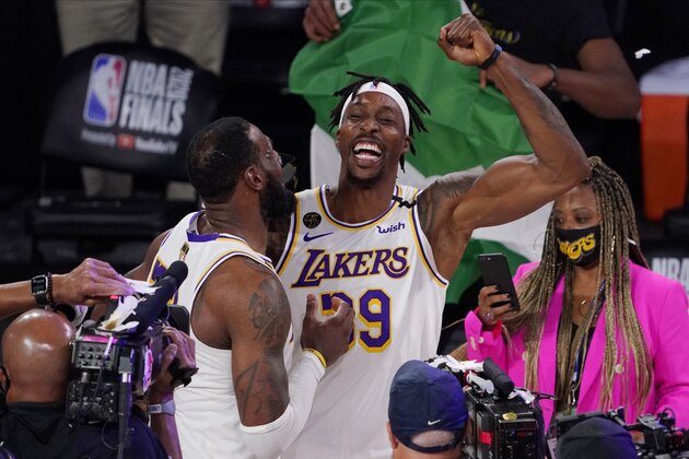 Los Angeles Lakers' LeBron James (23) and Los Angeles Lakers' Dwight Howard (39) celebrate after the Lakers defeated the Miami Heat 106-93 in Game 6 of basketball's NBA Finals Sunday, Oct. 11, 2020, in Lake Buena Vista, Fla. (AP Photo/Mark J. Terrill)