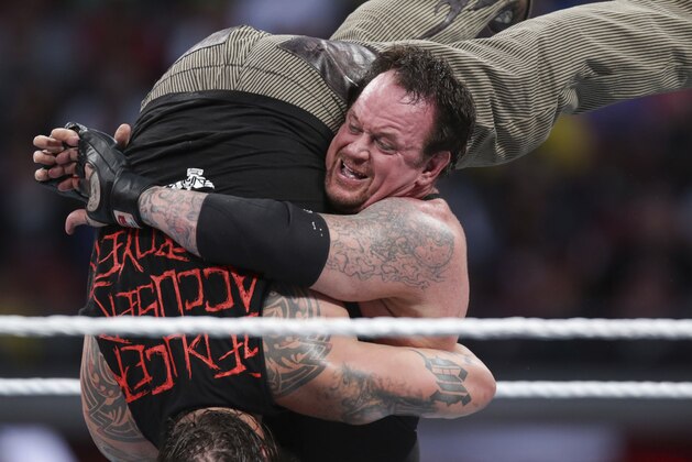 FILE - In this March 29, 2015, file photo, Bray Wyatt is upended by his opponent, The Undertaker, at Wrestlemania XXXI in Santa Clara, Calif. The WWE is set for its annual sports entertainment extravaganza Sunday, April 1, 2017,  in Orlando, Fla. John Cena, the Undertaker, the Miz and the Bella Twins all have big matches on the show.  (AP Photo/Don Feria, File)