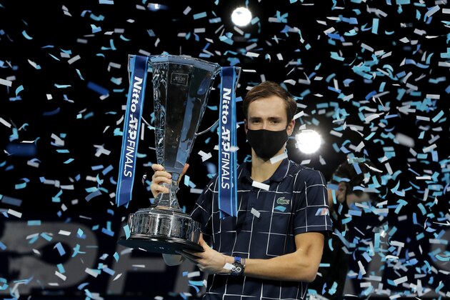 Daniil Medvedev of Russia holds up the winners trophy as confetti falls after defeating Dominic Thiem of Austria in the final of the ATP World Finals tennis match at the ATP World Finals tennis tournament at the O2 arena in London, Sunday, Nov. 22, 2020. (AP Photo/Frank Augstein)