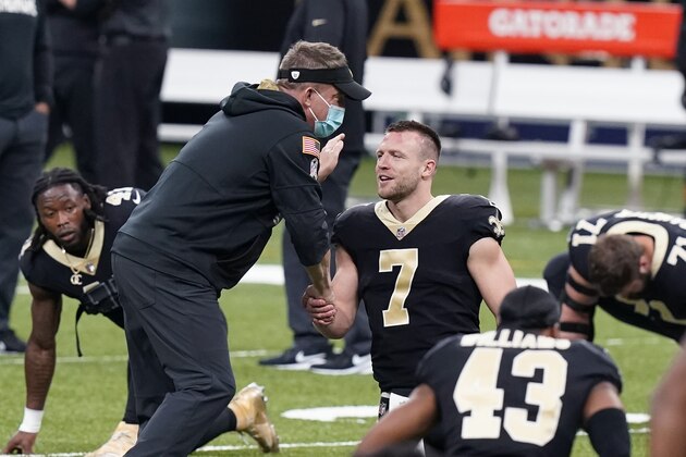 New Orleans Saints head coach Sean Payton greets quarterback Taysom Hill (7), starting for an injured Drew Brees, before an NFL football game against the Atlanta Falcons in New Orleans, Sunday, Nov. 22, 2020. (AP Photo/Butch Dill)