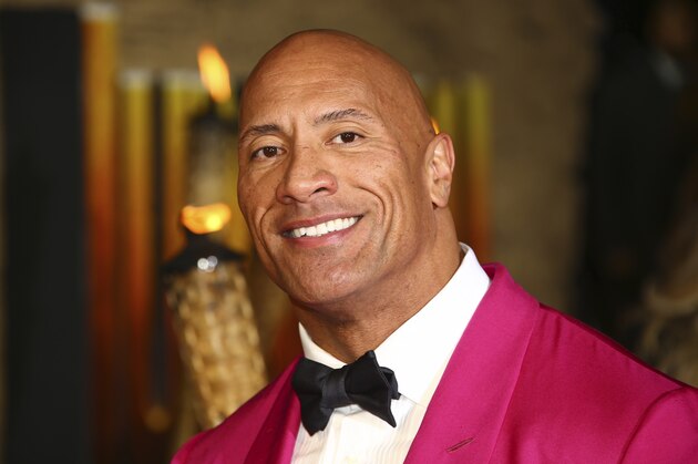 FILE - In this Dec. 5, 2019 file photo, actor Dwayne Johnson poses for photographers upon arrival at the premiere of the film 'Jumanji The Next Level', in central London.   Johnson will revisit his younger years in a new NBC comedy series called “The Rock,” which is the retired pro wrestler's nickname. NBC said Saturday, Jan. 11, 2020  that it's ordered 11 episodes of the show inspired by Johnson, who will appear and also serve as an executive producer.  (Photo by Joel C Ryan/Invision/AP)