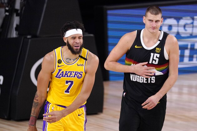 Los Angeles Lakers' JaVale McGee (7) reacts to a call during the first half of an NBA conference final playoff basketball game against the Denver Nuggets Thursday, Sept. 24, 2020, in Lake Buena Vista, Fla. At right is Denver Nuggets' Nikola Jokic (15). (AP Photo/Mark J. Terrill)