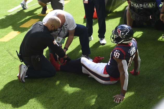 Houston Texans wide receiver Randall Cobb (18) is checked for an injury following his touchdown catch against the New England Patriots during the first half of an NFL football game, Sunday, Nov. 22, 2020, in Houston. (AP Photo/Eric Christian Smith)