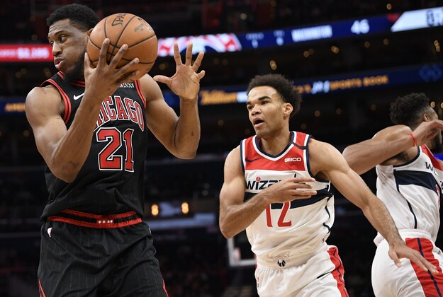 Chicago Bulls forward Thaddeus Young (21) handles the ball next to Washington Wizards guard Jerome Robinson (12) during the first half of an NBA basketball game, Tuesday, Feb. 11, 2020, in Washington. (AP Photo/Nick Wass)
