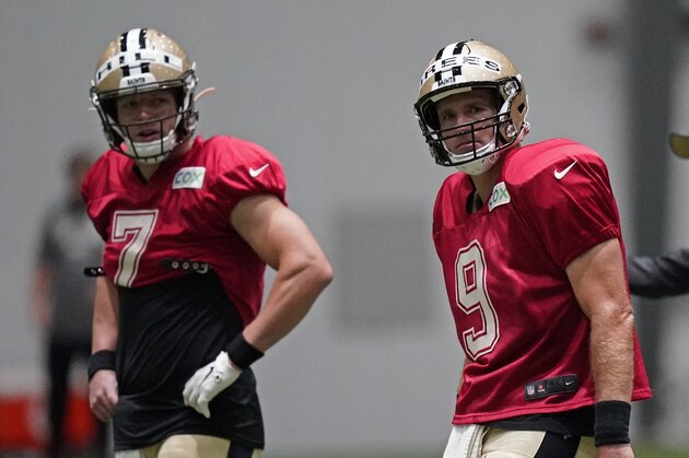New Orleans Saints quarterbacks Drew Brees (9) and Taysom Hill (7) go through drills in front of offensive coordinator Pete Carmichael during practice at their NFL football training facility in Metairie, La., Monday, Aug. 24, 2020. (AP Photo/Gerald Herbert, Pool)