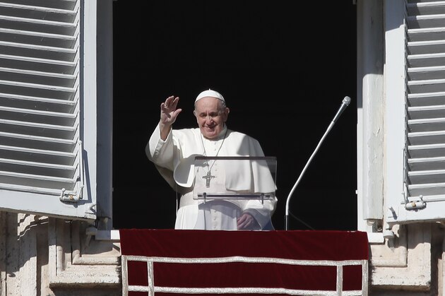 Pope Francis waves as he arrives for the Angelus noon prayer from the window of his studio overlooking St.Peter's Square, at the Vatican, Sunday, Nov. 22, 2020. (AP Photo/Alessandra Tarantino)
