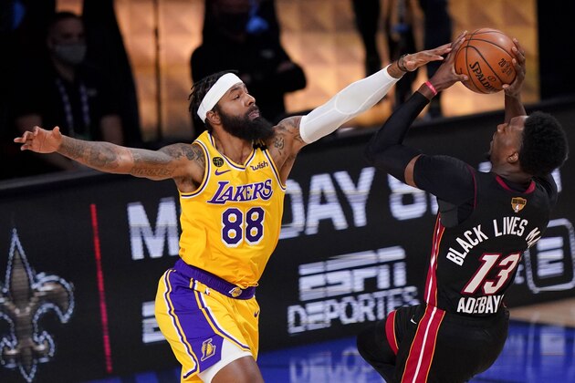 Los Angeles Lakers forward Markieff Morris, left, blocks a shot by Miami Heat forward Bam Adebayo during the first half in Game 4 of basketball's NBA Finals Tuesday, Oct. 6, 2020, in Lake Buena Vista, Fla. (AP Photo/Mark J. Terrill)