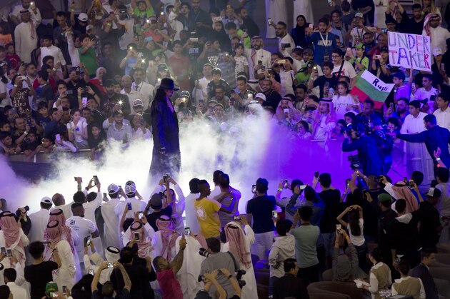 World Wrestling Entertainment star The Undertaker is greeted by fans during a match of the