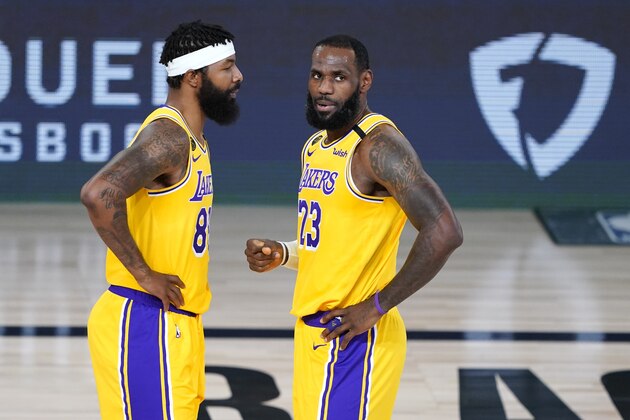 Los Angeles Lakers' LeBron James (23) talks with Markieff Morris (88) during the first half of an NBA basketball first round playoff game against the Portland Trail Blazers Saturday, Aug. 29, 2020, in Lake Buena Vista, Fla. (AP Photo/Ashley Landis)