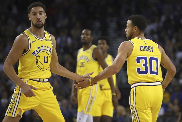 Golden State Warriors' Klay Thompson, left, and Stephen Curry (30) celebrate a score against the Milwaukee Bucks during the first half of an NBA basketball game Thursday, Nov. 8, 2018, in Oakland, Calif. (AP Photo/Ben Margot)
