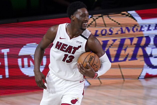 Miami Heat forward Bam Adebayo (13) celebrates after their NBA conference final playoff basketball game against the Boston Celtics on Thursday, Sept. 17, 2020, in Lake Buena Vista, Fla. The Heat won 106-101. (AP Photo/Mark J. Terrill)