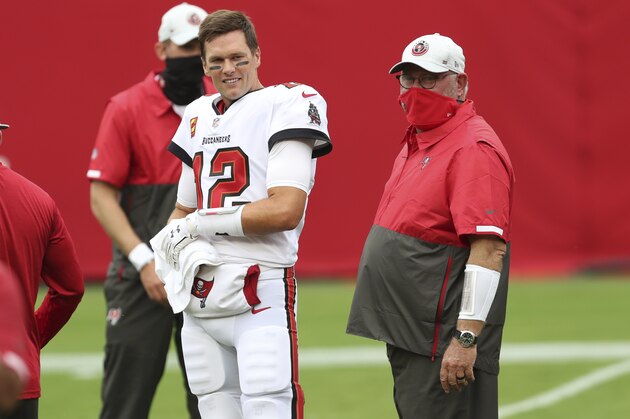 Tampa Bay Buccaneers quarterback Tom Brady (12) talks to head coach Bruce Arians before an NFL football game against the Los Angeles Chargers Sunday, Oct. 4, 2020, in Tampa, Fla. (AP Photo/Mark LoMoglio)