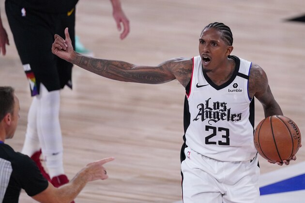 Los Angeles Clippers' Lou Williams (23) argues a call by referee Josh Tiven, left, during the second half of an NBA conference semifinal playoff basketball game against the Denver Nuggets Sunday, Sept. 13, 2020, in Lake Buena Vista, Fla. (AP Photo/Mark J. Terrill)