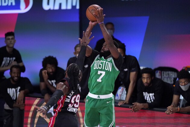 Miami Heat's Jae Crowder (99) defends against a shot attempt by Boston Celtics' Jaylen Brown (7) during the first half of an NBA conference final playoff basketball game, Saturday, Sept. 19, 2020, in Lake Buena Vista, Fla. (AP Photo/Mark J. Terrill)