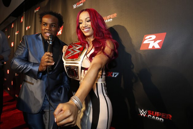 IMAGE DISTRIBUTED FOR 2K - WWE Women's Champion Sasha Banks speaks with WWE Superstar Xavier Woods, left, on the red carpet at the WWE 2K17 SummerSlam Kickoff Event in New York, on Friday, Aug. 19, 2016. (Adam Hunger/AP Images for 2K)