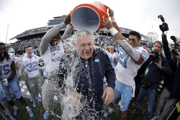 North Carolina head coach Mack Brown, center, is doused by defensive back Patrice Rene, left, and linebacker Chazz Surratt during the second half of the Military Bowl NCAA college football game against Temple, Friday, Dec. 27, 2019, in Annapolis, Md. North Carolina won 55-13. (AP Photo/Julio Cortez) North Carolina head coach Mack Brown, center, is doused by defensive back Patrice Rene, left, and linebacker Chazz Surratt during the second half of the Military Bowl NCAA college football game against Temple, Friday, Dec. 27, 2019, in Annapolis, Md. North Carolina won 55-13. (AP Photo/Julio Cortez)