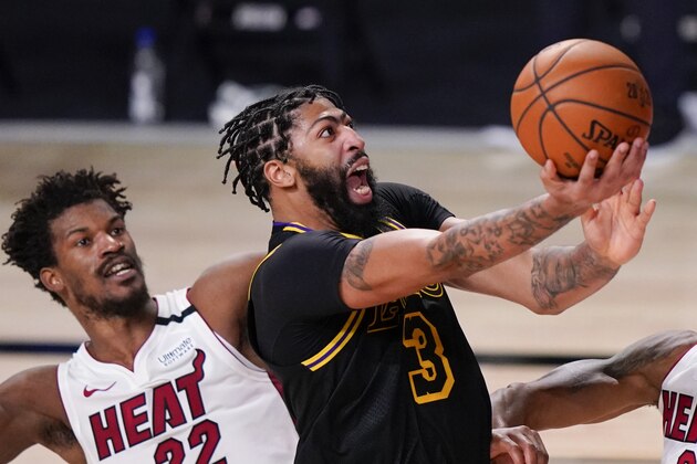 FILE - In this Oct. 9, 2020, file photo, Los Angeles Lakers forward Anthony Davis shoots past Miami Heat forward Jimmy Butler during the second half in Game 5 of basketball's NBA Finals in Lake Buena Vista, Fla. Davis is the biggest name on the free agency board; he turned down his option for this season with the Lakers but isnâ€™t expected to go anyplace else. (AP Photo/Mark J. Terrill, File)