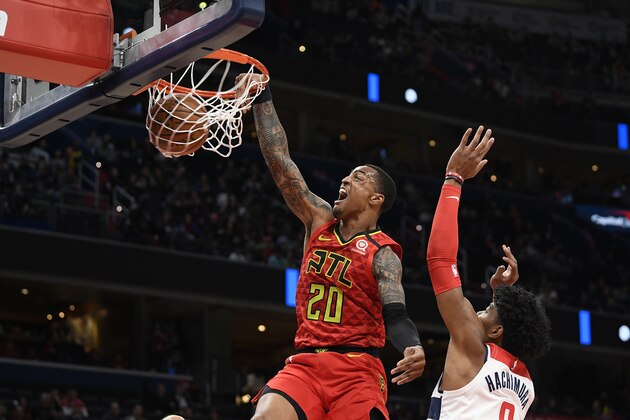 Atlanta Hawks forward John Collins (20) dunks past Washington Wizards forward Rui Hachimura (8), of Japan, during the first half of an NBA basketball game, Friday, March 6, 2020, in Washington. (AP Photo/Nick Wass)