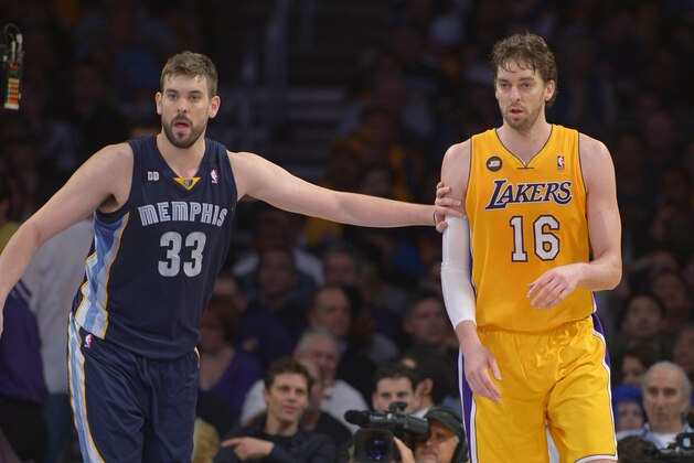 Memphis Grizzlies center Marc Gasol, left, of Spain, guards Los Angeles Lakers forward Pau Gasol, of Spain, look on during the second half of their NBA basketball game, Friday, April 5, 2013, in Los Angeles. (AP Photo/Mark J. Terrill)
