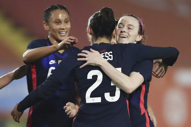 United States players celebrate with teammate Rose Lavelle, right, who scored her side's first goal during the international friendly women's soccer match between The Netherlands and the US at the Rat Verlegh stadium in Breda, southern Netherlands, Friday Nov. 27, 2020. (Dean Mouhtaropoulos/Pool via AP)