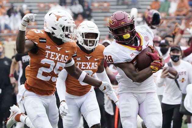 Iowa State running back Breece Hall (28) runs past Texas defensive back B.J. Foster (25) during the first half of an NCAA college football game, Friday, Nov. 27, 2020, in Austin, Texas. (AP Photo/Eric Gay)