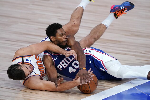 Phoenix Suns forward Dario Saric, left, and Philadelphia 76ers forward Glenn Robinson III (40) battle for the ball during the second half of an NBA basketball game Tuesday, Aug. 11, 2020, in Lake Buena Vista, Fla. (AP Photo/Ashley Landis, Pool)