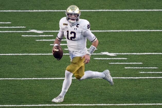 Notre Dame quarterback Ian Book (12) scrambles against North Carolina during the first half of an NCAA college football game in Chapel Hill, N.C., Friday, Nov. 27, 2020. (AP Photo/Gerry Broome)